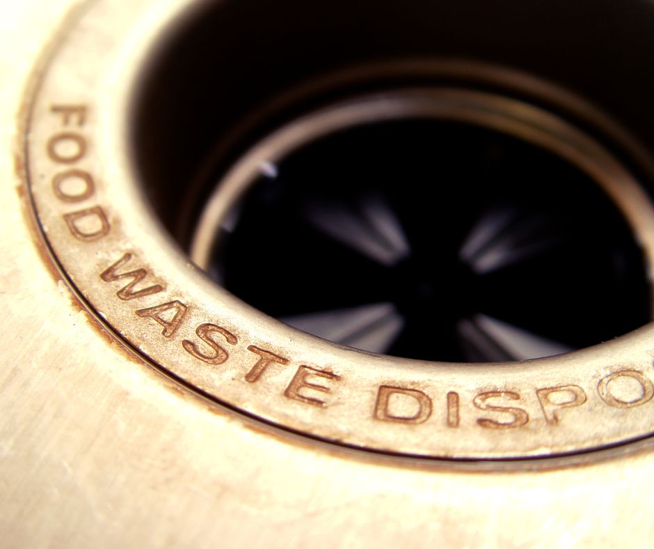 Close up of the basin of a kitchen sink with Food Waste Disposal.