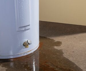 Image of a leaking water heater with drips all down the unit.