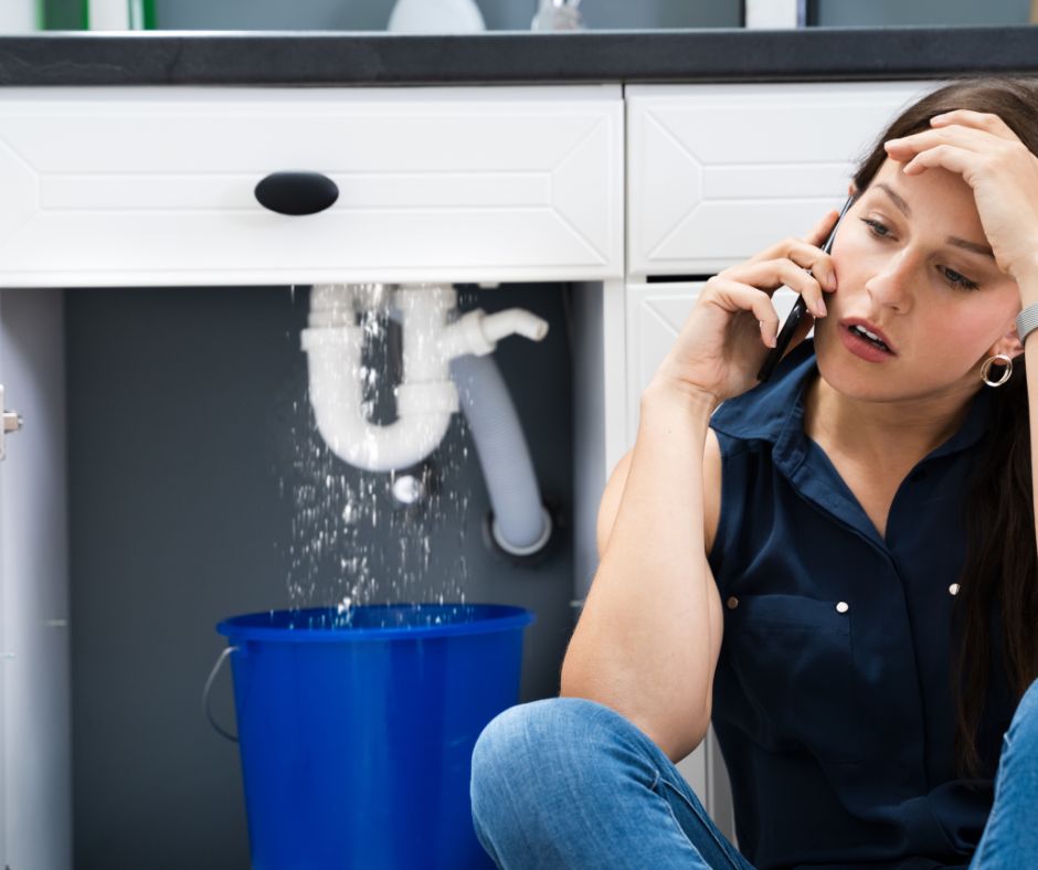 Call the experts for Plumbing tips for Florida image of a lady looking at water leaking into a blue bucket.